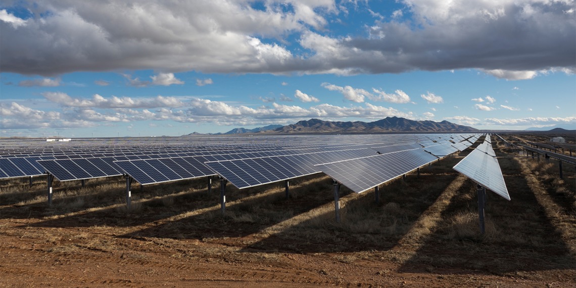 A field of solar panels in the desert.