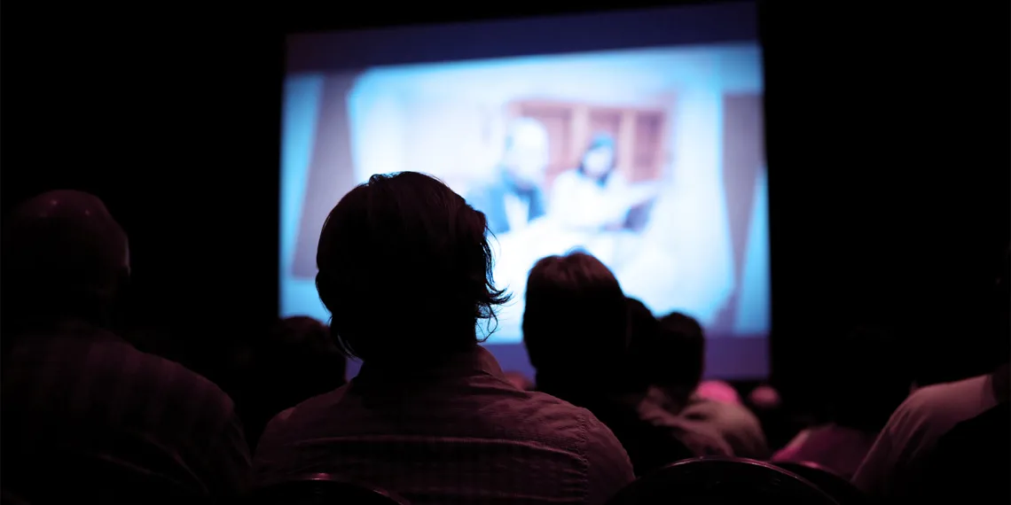 People watching a film in a movie theater.