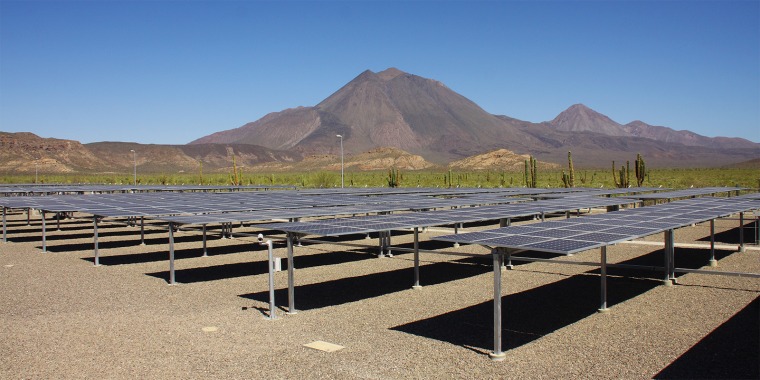 Rows of solar panels in the desert.